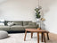 gray 2 seat sofa near brown wooden coffee table